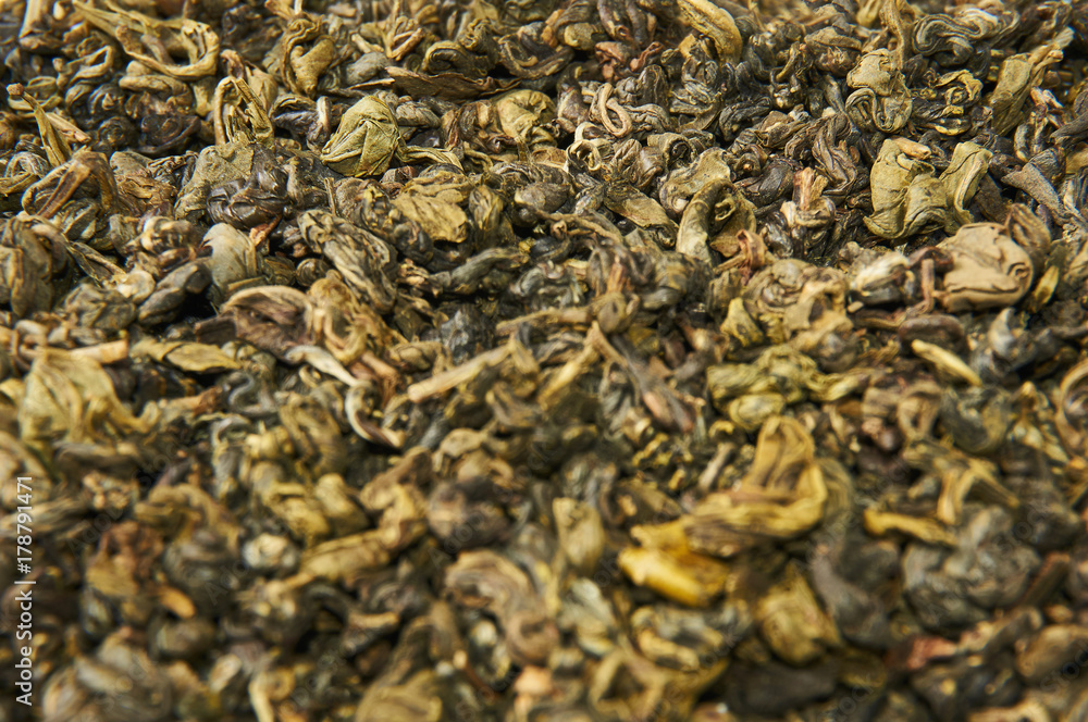 A pile of dry green tea. Isolated on white background. Food background. A pile of dry green tea. Isolated on white background. Food background.