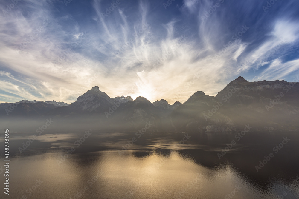 Shades of a half tone of blue. Panorama of the mountain landscape. Clouds over the peaks. Lake Lucerne. Swiss Alps.