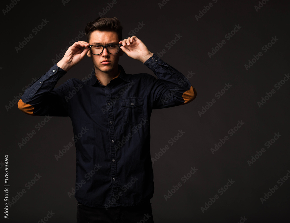 Young sexy man portrait of a confident businessman on a black background. Ideal for banners, registration forms, presentation, landings, presenting concept. Young sexy man portrait of a confident businessman on a black background. Ideal for banners, registration forms, presentation, landings, presenting concept.