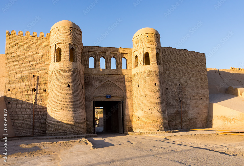 Sunset on twin-turreted south entrance Gate in the ancient city wall of Ichan Kala - Khiva, Uzbekistan
