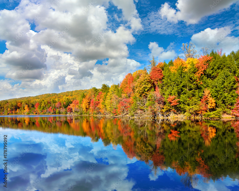 Obraz premium Landscape of autumn colored trees with reflection in Bays Mountain Lake in Kingsport, Tennessee