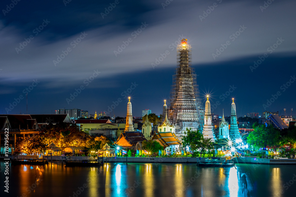 Wat Arun Temple beside Chao Phraya River at twilight time in Bangkok, Thailand. One of the most famous place of Thailand's landmarks. Light reflection on smooth water. Wat Arun Temple beside Chao Phraya River at twilight time in Bangkok, Thailand. One of the most famous place of Thailand's landmarks. Light reflection on smooth water.