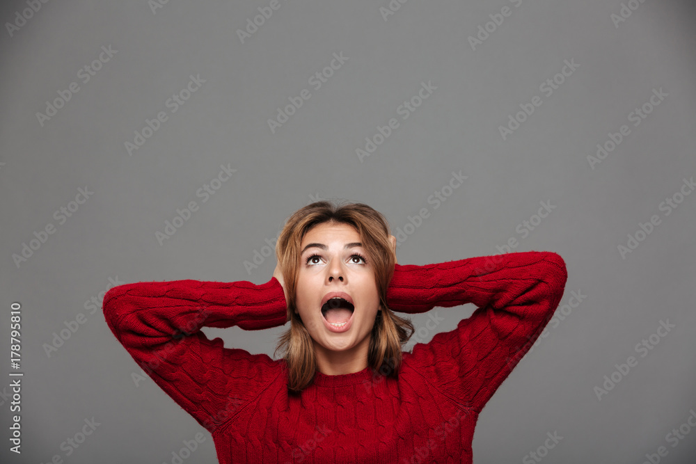 Portrait of a scared young girl screaming and looking up Portrait of a scared young girl screaming and looking up