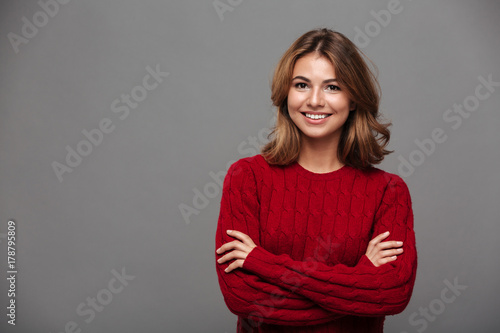 Portrait of a young smiling girl in red sweater