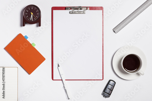 red clipboard with smart phone, stationary on the white background.