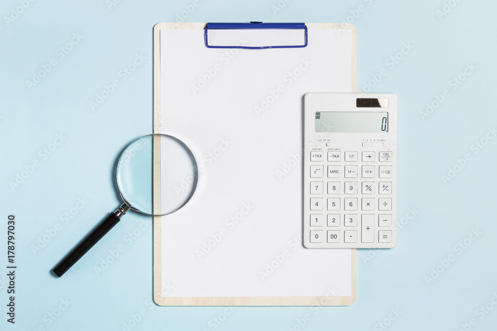 clipboard, magnifier, calculator on the blue background. clipboard, magnifier, calculator on the blue background.
