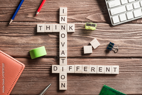 Conceptual keywords on wooden table with elements of game making crossword