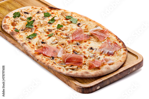 Italian pizza on a wooden chopping board.