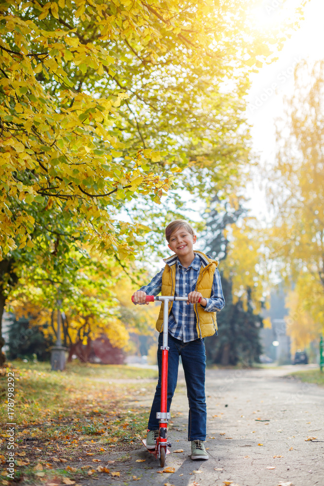 Cute little kid boy enjoying in autumn park. Cute little kid boy enjoying in autumn park.