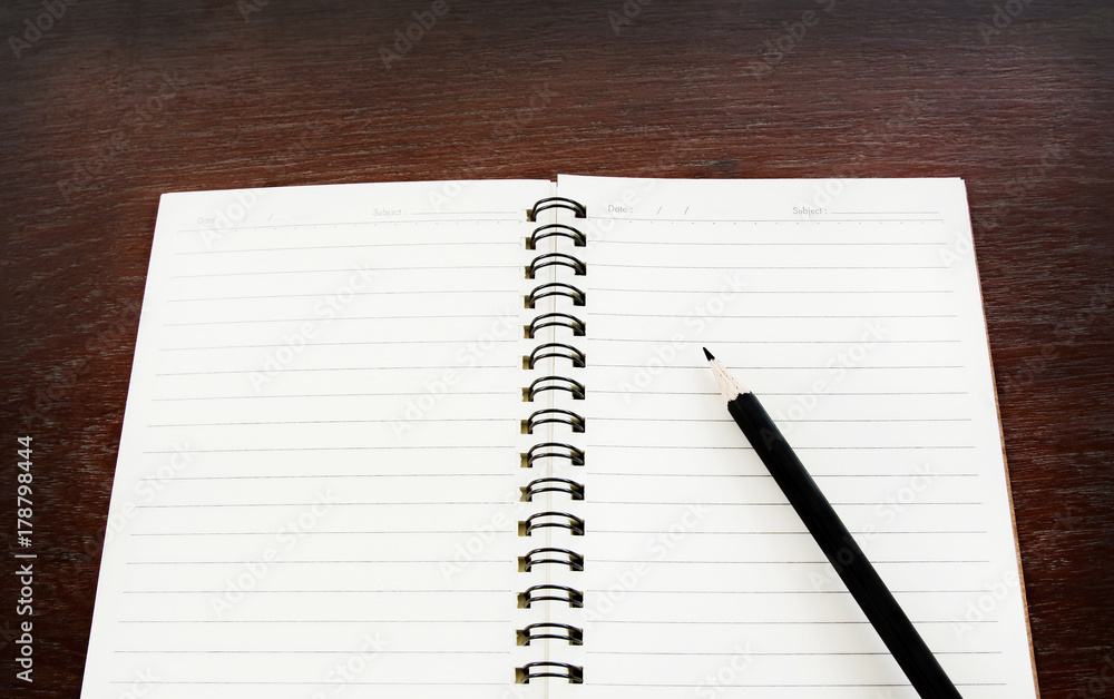 Open notebook and pencil on old wooden table, selective focus for copy space. Open notebook and pencil on old wooden table, selective focus for copy space.