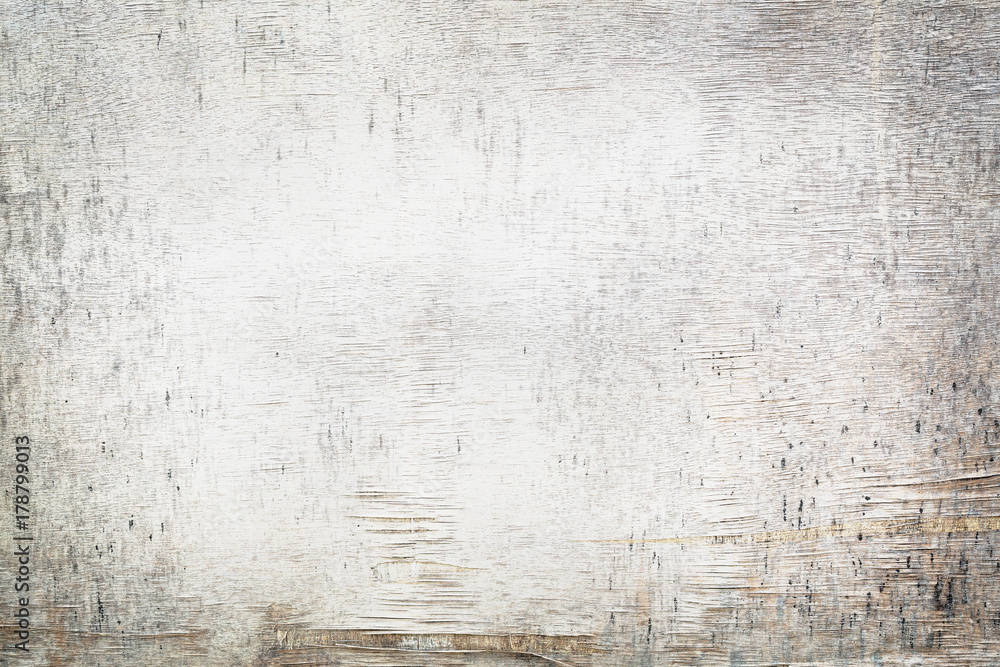 Obraz premium damaged old white painted plywood in sunlight, grunge background