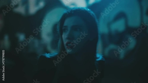 Girl in fear looks at her hands and runs away