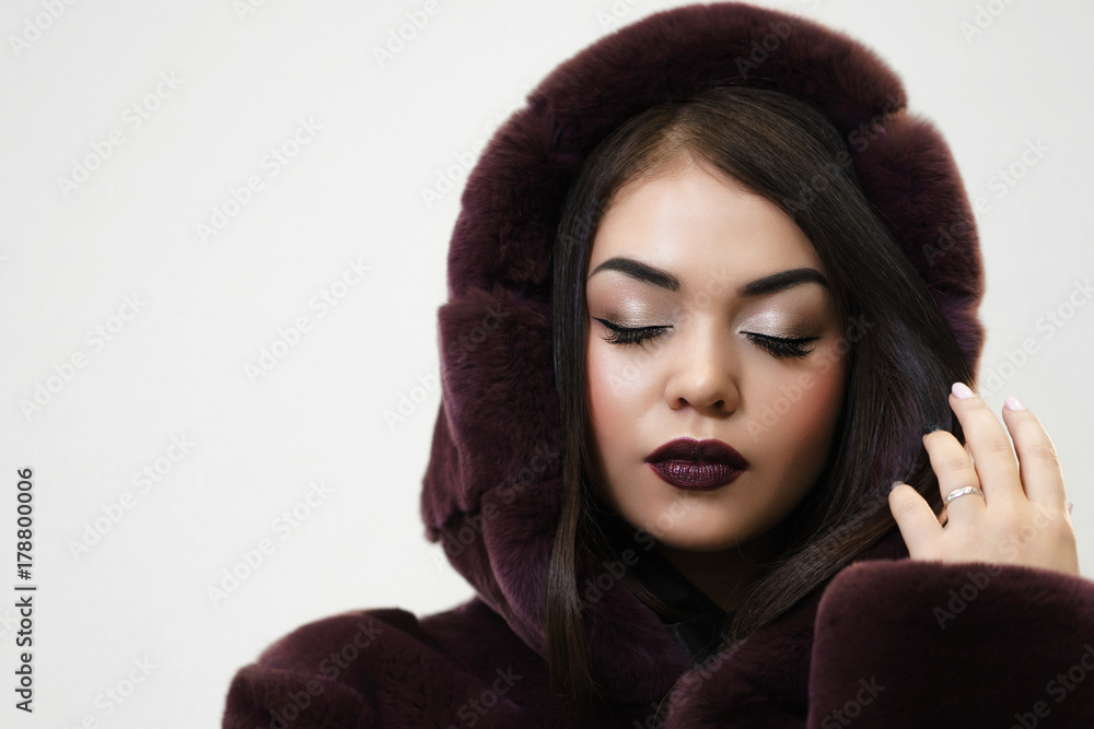 Portrait of Young beautiful Woman in Luxury Fur Coat with copy space for text Portrait of Young beautiful Woman in Luxury Fur Coat with copy space for text