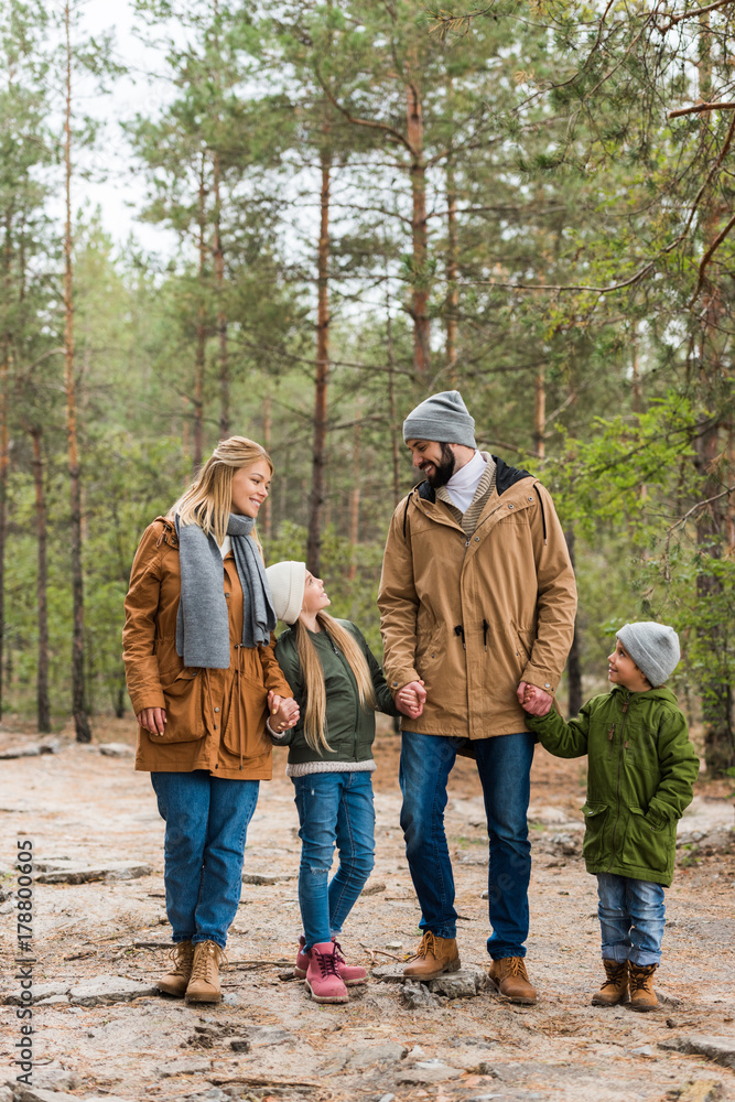 family walking by forest together family walking by forest together