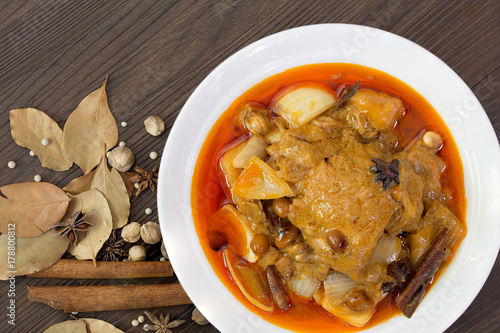 Mussaman curry chicken in white bowl with spices and herbs  / Halal food and selective focus..