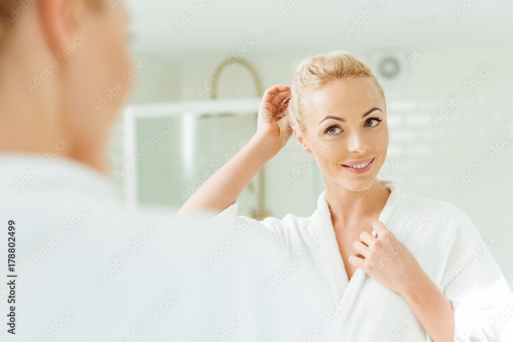 Fototapeta premium beautiful woman looking at mirror