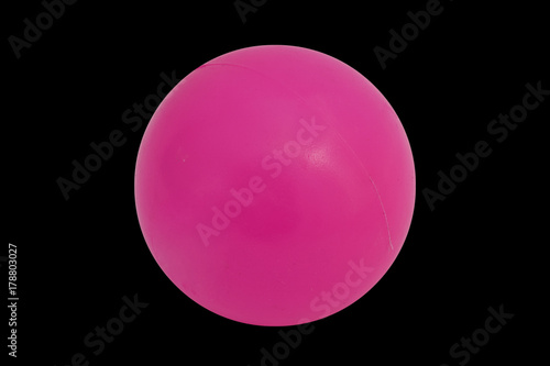 Pink plastic ball cut out on and isolated on a black background