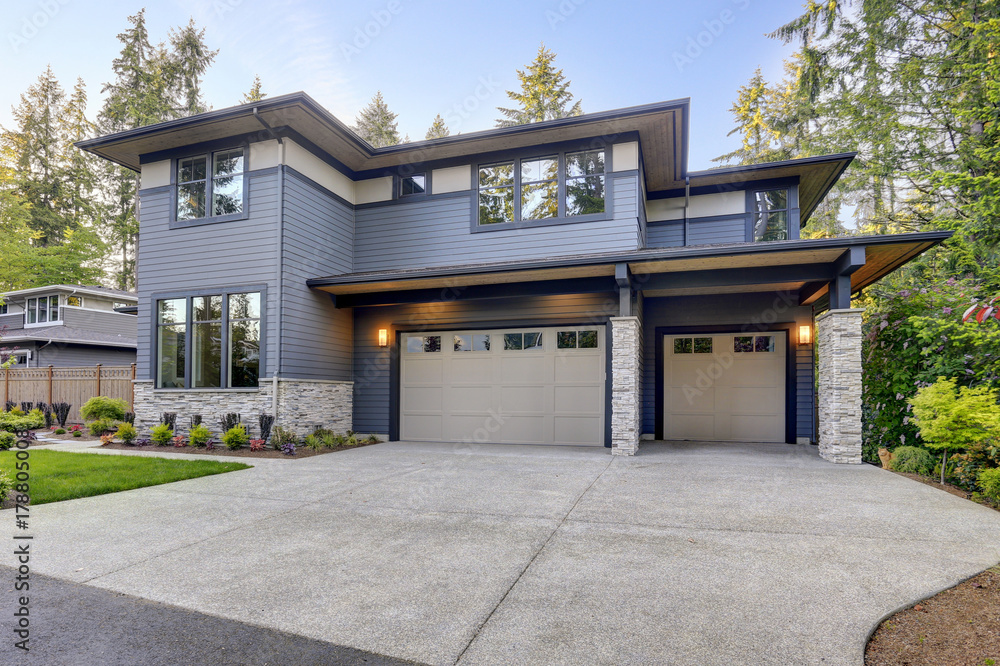 New construction home with wood and stone siding New construction home with wood and stone siding