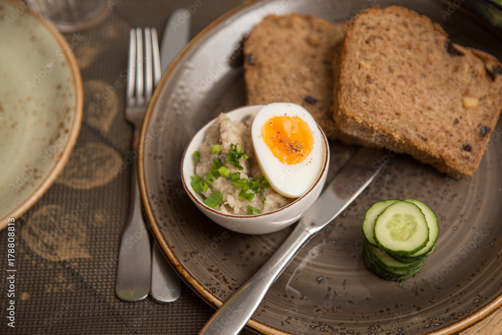 farshmak with bread, cucumber and half cooked egg