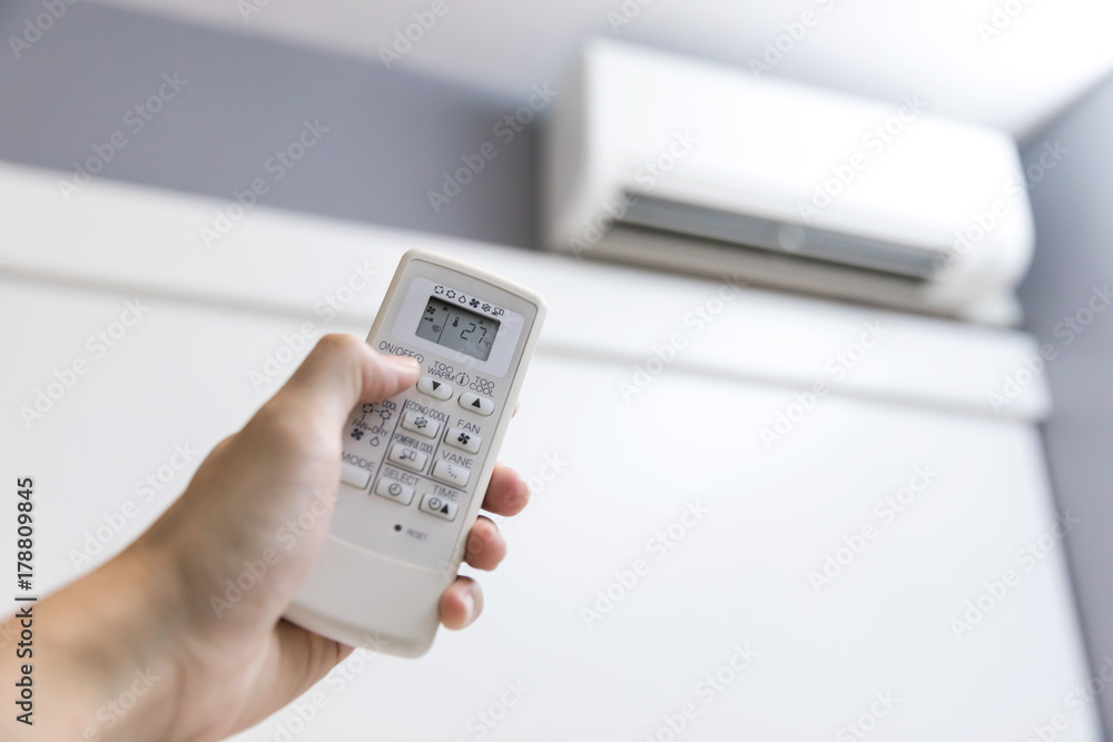Hand hold remote control operating air conditioner Hand hold remote control operating air conditioner