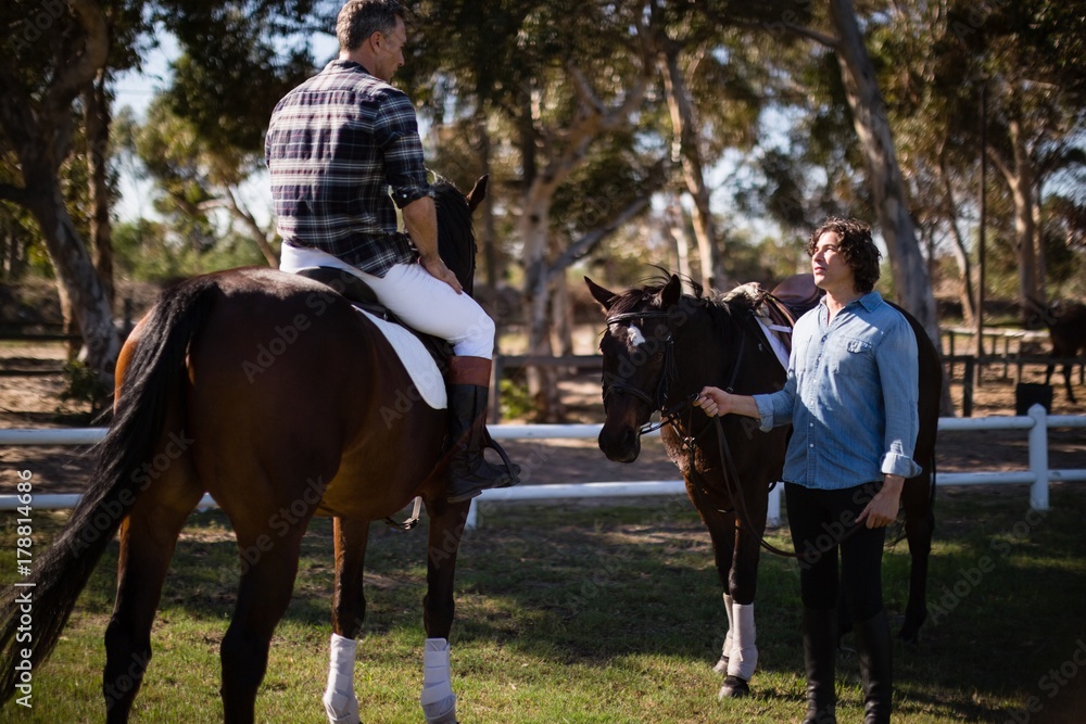 Two male friends interacting with each other in the ranch Two male friends interacting with each other in the ranch