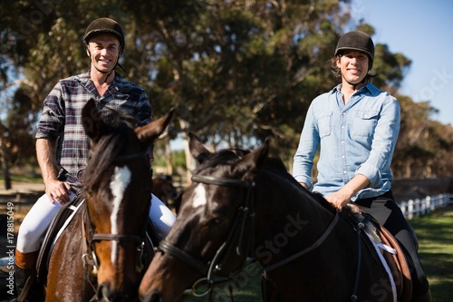 Two male friends riding horse in the ranch © WavebreakMediaMicro