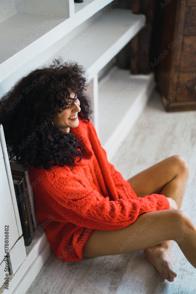 Happy woman sitting on floor