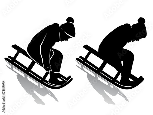 silhouette of a kid riding a sleigh