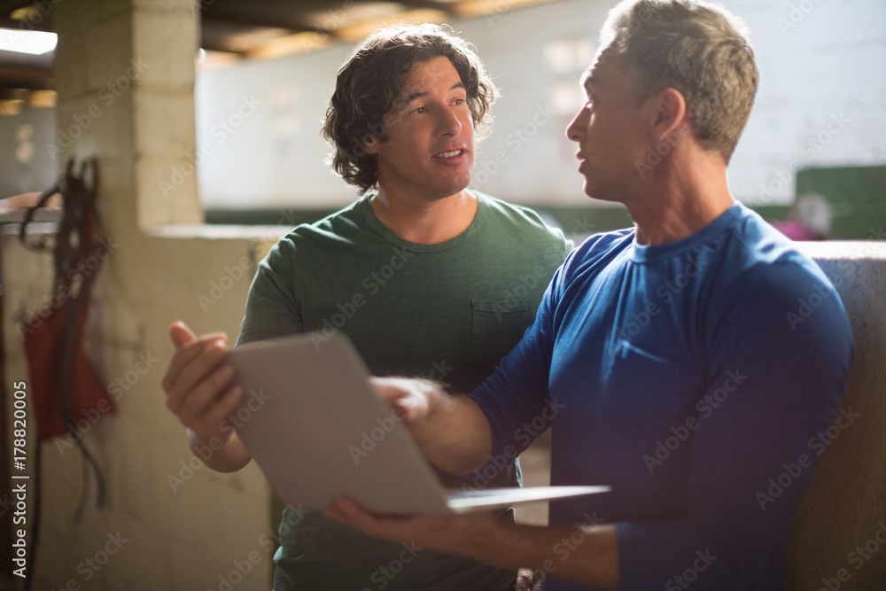 Two male friends using laptop Two male friends using laptop