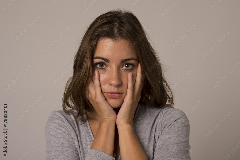 portrait of young beautiful and sweet woman looking sad and devastated in sadness emotion portrait of young beautiful and sweet woman looking sad and devastated in sadness emotion