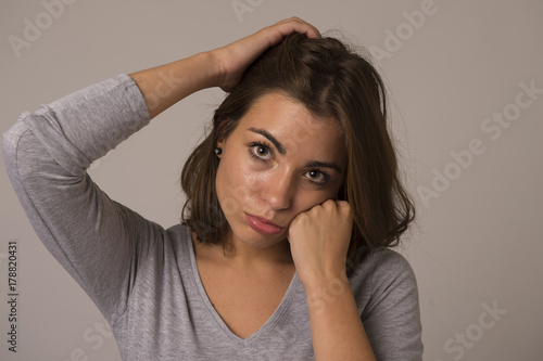 portrait of young beautiful and sweet woman looking sad and devastated in sadness emotion