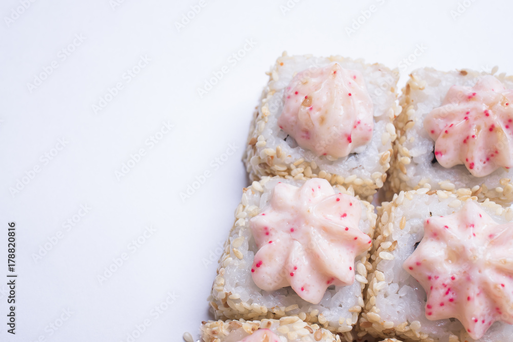 Sushi rolls with sesame seeds and sauce over white background Sushi rolls with sesame seeds and sauce over white background