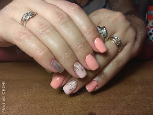 The manicurist excellently made her work a beautiful manicure with a polish gel on her hands and the client is happy