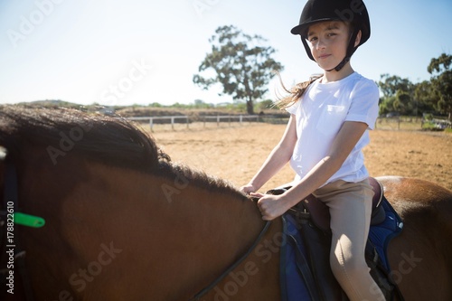 Girl riding a horse in the ranch © WavebreakMediaMicro