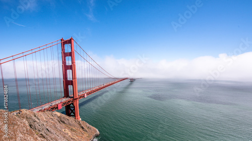Canvas-taulu Golden Gate Bridge in clouds on a beautiful summer day  - Panoramic view from Ba