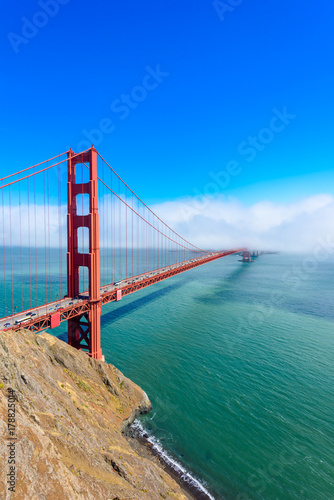 Golden Gate Bridge in clouds on a beautiful summer day - Panoramic view from Battery Spencer - California, USA