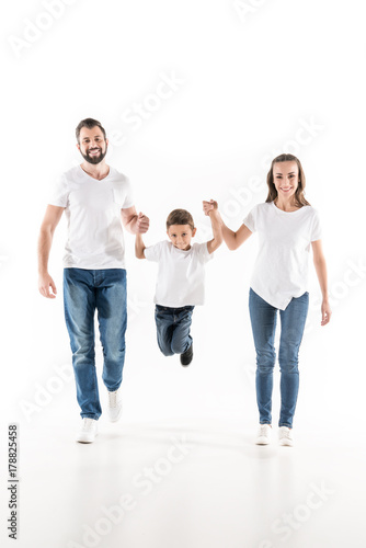 parents and son holding hands