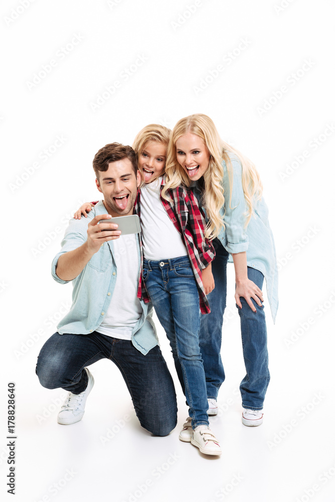 Full length portrait of a joyful young family Full length portrait of a joyful young family