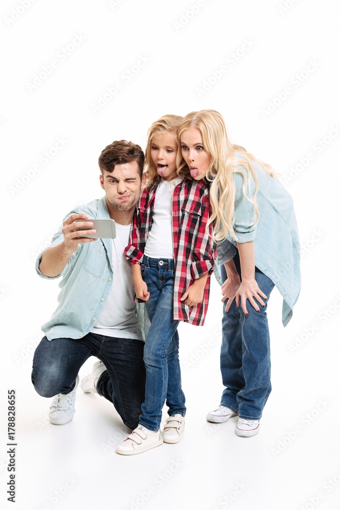 Full length portrait of a cheerful young family Full length portrait of a cheerful young family