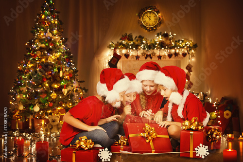 Christmas Children Open Present Gift Box, Happy Kids Opening Giftbox in Xmas Tree Home Interior