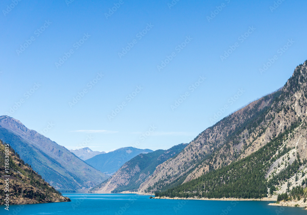 Seton lake near Lillooet British Columbia Canada high mountains with blue sky.