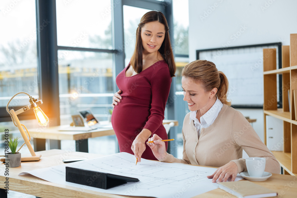 Obraz premium Hardworking designers discussing important working matters