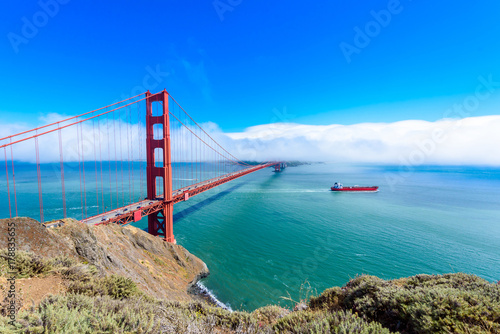 Canvas-taulu Golden Gate Bridge in clouds on a beautiful summer day  - Panoramic view from Ba