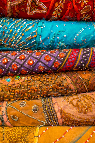 Close up of heap of cloth fabrics at a local market in India, vertical view