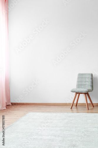 Fototapeta Naklejka Na Ścianę i Meble -  Grey chair in bright interior