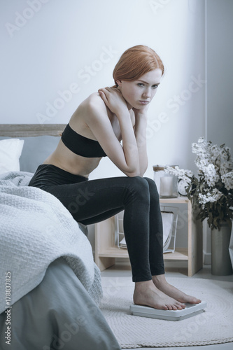 Unhealthy girl with anorexia problem photo