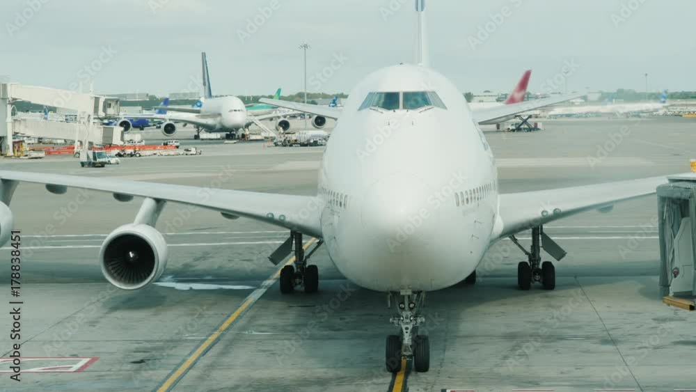The arrival of a giant two-story airliner to the terminal. Slowly approaching the hub The arrival of a giant two-story airliner to the terminal. Slowly approaching the hub