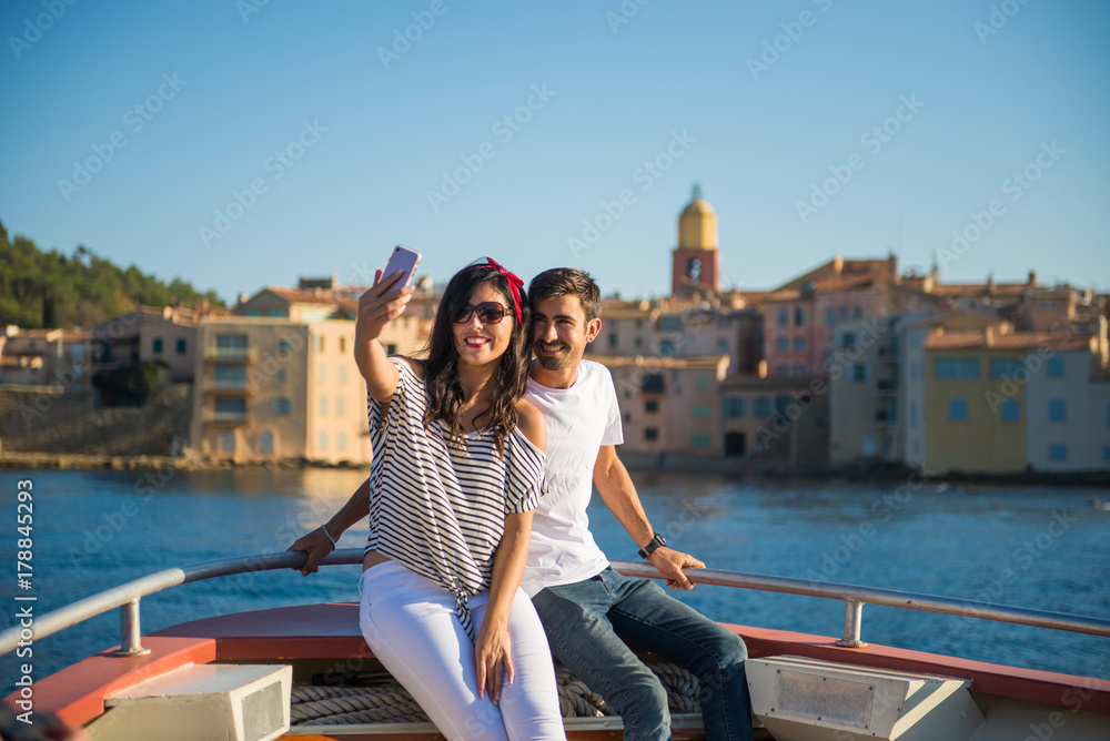 Smiling Couple Happy Taking Selfie on Boat Ride at Saint-Tropez, Cote d'Azur, France