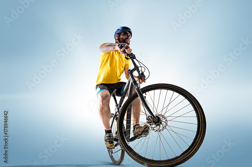 Fototapeta Naklejka Na Ścianę i Meble -  The bicyclist on gray, studio shot.