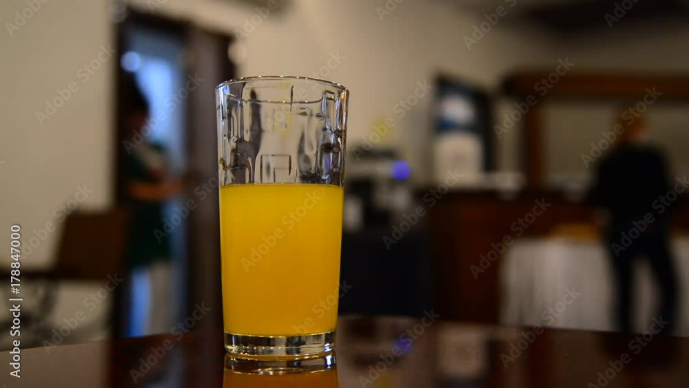 Glass of orange juice on a table in a cafe Glass of orange juice on a table in a cafe